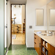 view of the bathroom featuring timber veneer cabinetry, architecture, bathroom, floor, flooring, home, interior design, real estate, room, white