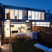 An exterior view of the patio area. - apartment, architecture, building, cottage, estate, facade, home, house, property, real estate, residential area, window, black, blue