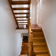 A view of a wooden staircase. - A daylighting, handrail, hardwood, home, house, interior design, stairs, wood, gray, brown