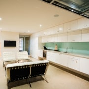 A viewof the kitchen and dining areas, polished ceiling, countertop, interior design, kitchen, real estate, room, white