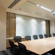 A view of a air conditioning system by architecture, ceiling, conference hall, daylighting, furniture, interior design, light fixture, lighting, office, table, black, orange