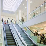 A view of some work by Amstar Construction. architecture, building, ceiling, daylighting, escalator, glass, handrail, interior design, leisure centre, lobby, shopping mall, stairs, structure, white, gray