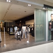 A view of a shop designed by Adrian boutique, interior design, retail, shopping mall, gray