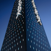 A view of some signage by Corada. - architecture, building, commercial building, corporate headquarters, daytime, facade, landmark, metropolis, metropolitan area, sky, skyscraper, tower, tower block, blue, black