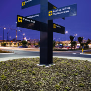 A view of some signage by Corada. - night, sky, tree, blue, black