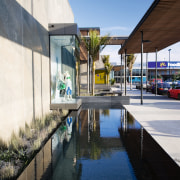 A view of a water feature by Mayfair architecture, building, condominium, house, mixed use, real estate, reflection, sky, swimming pool, water, black, white