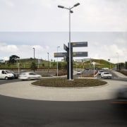 A view of the roading by Flow Transportation asphalt, car, parking lot, road, sky, street, street light, white, black