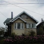 An exterior view of the home. - An architecture, building, cottage, facade, farmhouse, historic house, home, house, neighbourhood, property, real estate, residential area, roof, siding, sky, suburb, tree, window, white, black