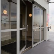 view of the motion activated security doors constructed door, glass, window, gray, black