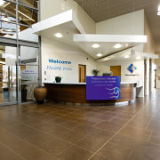 A view of the Papamoa Library constructed by ceiling, floor, flooring, institution, interior design, lobby, real estate, brown, white