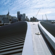 view of the Dimond Dimondek 630 roofing profile architecture, bridge, building, city, condominium, daytime, downtown, fixed link, infrastructure, line, metropolis, metropolitan area, roof, sky, skyline, skyscraper, skyway, structure, tower block, urban area, white, black