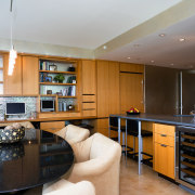 View of the kitchen and dining area featuring cabinetry, countertop, interior design, kitchen, living room, real estate, room
