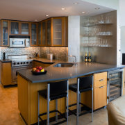 View of the kitchen and dining area featuring cabinetry, countertop, cuisine classique, interior design, kitchen, real estate, room, brown, gray