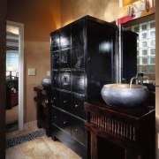 A view of the bathroom, tiled floor, brown cabinetry, furniture, interior design, kitchen, room, black