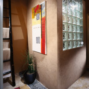 A view of some artwork in the bathroom. furniture, interior design, shelf, shelving, brown, gray