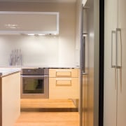 view of the kitchen featuring bamboo flooring, Techistone cabinetry, countertop, floor, flooring, hardwood, home appliance, interior design, kitchen, room, gray, orange