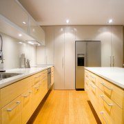 view of the kitchen featuring bamboo flooring, Techistone bathroom, cabinetry, ceiling, countertop, floor, home, interior design, kitchen, property, real estate, room, sink, gray, orange