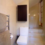 The toilet was repoistioned beside the entry stairs. architecture, bathroom, ceiling, daylighting, estate, floor, flooring, home, house, interior design, plumbing fixture, property, real estate, room, sink, tile, toilet, wall, gray