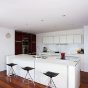 Spanish Red lacquered cabinets contrast with pure white apartment, architecture, ceiling, floor, furniture, house, interior design, kitchen, real estate, table, white