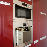 A close up view of the stainless steel cabinetry, countertop, home appliance, interior design, kitchen, kitchen stove, major appliance, product design, room, red