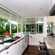 A view of the kitchen area, wooden flooring architecture, countertop, daylighting, estate, house, interior design, kitchen, property, real estate, window, gray