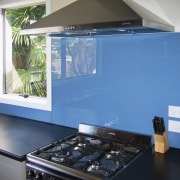A view of a glass splashback by Glass countertop, glass, home appliance, interior design, kitchen, room, window, teal