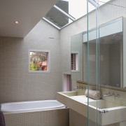 A view of the bathrom featuring tiled walls/flooring, architecture, bathroom, ceiling, daylighting, home, interior design, room, gray