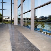 A viewof some polished concrete flooring by ACO apartment, architecture, building, condominium, floor, flooring, real estate, reflection, sky, walkway, water, window, gray