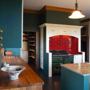 A view of some kitchen cabinetry by The cabinetry, countertop, furniture, hardwood, home, interior design, kitchen, living room, room, table, wood, black