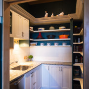 A view of some kitchen cabinetry by The cabinetry, countertop, cuisine classique, interior design, kitchen, room, under cabinet lighting, black