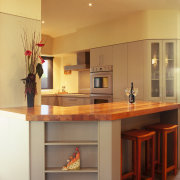 A view of some kitchen cabinetry by the cabinetry, countertop, cuisine classique, floor, flooring, furniture, interior design, kitchen, room, table, orange, brown