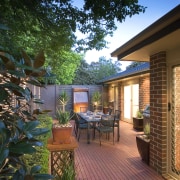 A view of this out door entertainment area backyard, courtyard, deck, estate, home, house, landscaping, outdoor structure, patio, property, real estate, yard