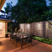 A view of this out door entertainment area backyard, courtyard, deck, estate, home, house, landscaping, lighting, outdoor structure, patio, plant, property, real estate, roof, yard, brown, black