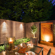 A view of this out door entertainment area backyard, home, house, interior design, landscape lighting, lighting, outdoor structure, property, real estate, brown