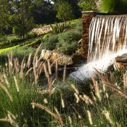 View of the landscaped gardens around the golf body of water, grass, grass family, landscape, nature, nature reserve, plant, tree, vegetation, water, water feature, water resources, watercourse, waterfall, brown
