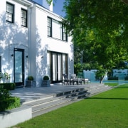 A view of the outdoor entertaining area featuring architecture, building, cottage, courtyard, estate, facade, grass, home, house, lawn, mansion, neighbourhood, property, real estate, residential area, urban design, villa, yard, green