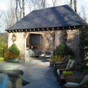 Exterior view of pool house with stone cladding backyard, cottage, estate, home, house, outdoor structure, property, real estate, shed, black
