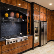 View of this kitchen featuring tiled flooring, lacquered cabinetry, countertop, flooring, home appliance, kitchen, room, brown, orange, black