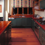 A view of some kitchen cabinetry by Kings cabinetry, countertop, cuisine classique, floor, flooring, furniture, hardwood, interior design, kitchen, room, wood, wood flooring, wood stain, red, black