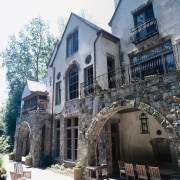 View of Normandy style home with stone and architecture, building, facade, home, house, mansion, medieval architecture, neighbourhood, real estate, window, white, black