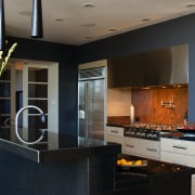 A view of the kitchen area, wooden cabinetry, countertop, interior design, kitchen, room, black