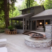 An exterior view of the patio area. - backyard, cottage, deck, home, house, outdoor structure, patio, real estate, yard, black, gray