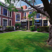 A view of the Peterborough Apartments,  architect architecture, backyard, building, cottage, courtyard, estate, facade, garden, grass, historic house, home, house, landscaping, lawn, mansion, neighbourhood, plant, plantation, property, real estate, residential area, tree, window, yard, green