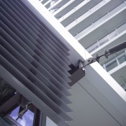 A close up view of some aluminium louvres angle, architecture, building, ceiling, daylighting, daytime, facade, glass, house, line, roof, siding, steel, structure, window, gray