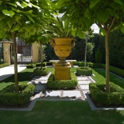 A view of this  Mediteranean style house arecales, courtyard, garden, grass, hedge, landscape, landscaping, lawn, leaf, outdoor structure, plant, shrub, tree, yard, brown, green