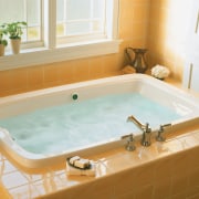 View of recessed white bath with yellow tiled bathroom, bathroom sink, bathtub, floor, jacuzzi, plumbing fixture, room, sink, white, orange