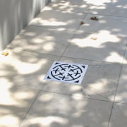 A view of some swimming pool grates. - floor, font, line, pattern, road surface, gray, white