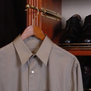 View of valet rod in closet storage unit. clothes hanger, collar, dress shirt, outerwear, shirt, sleeve, suit, textile, gray, black