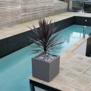 A view of some planters by Bentleigh By floor, flooring, furniture, property, swimming pool, table, tile, wall, wood, gray