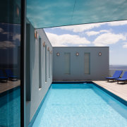 A view of a home by Creative Architecture. architecture, house, real estate, sky, swimming pool, water, teal, black